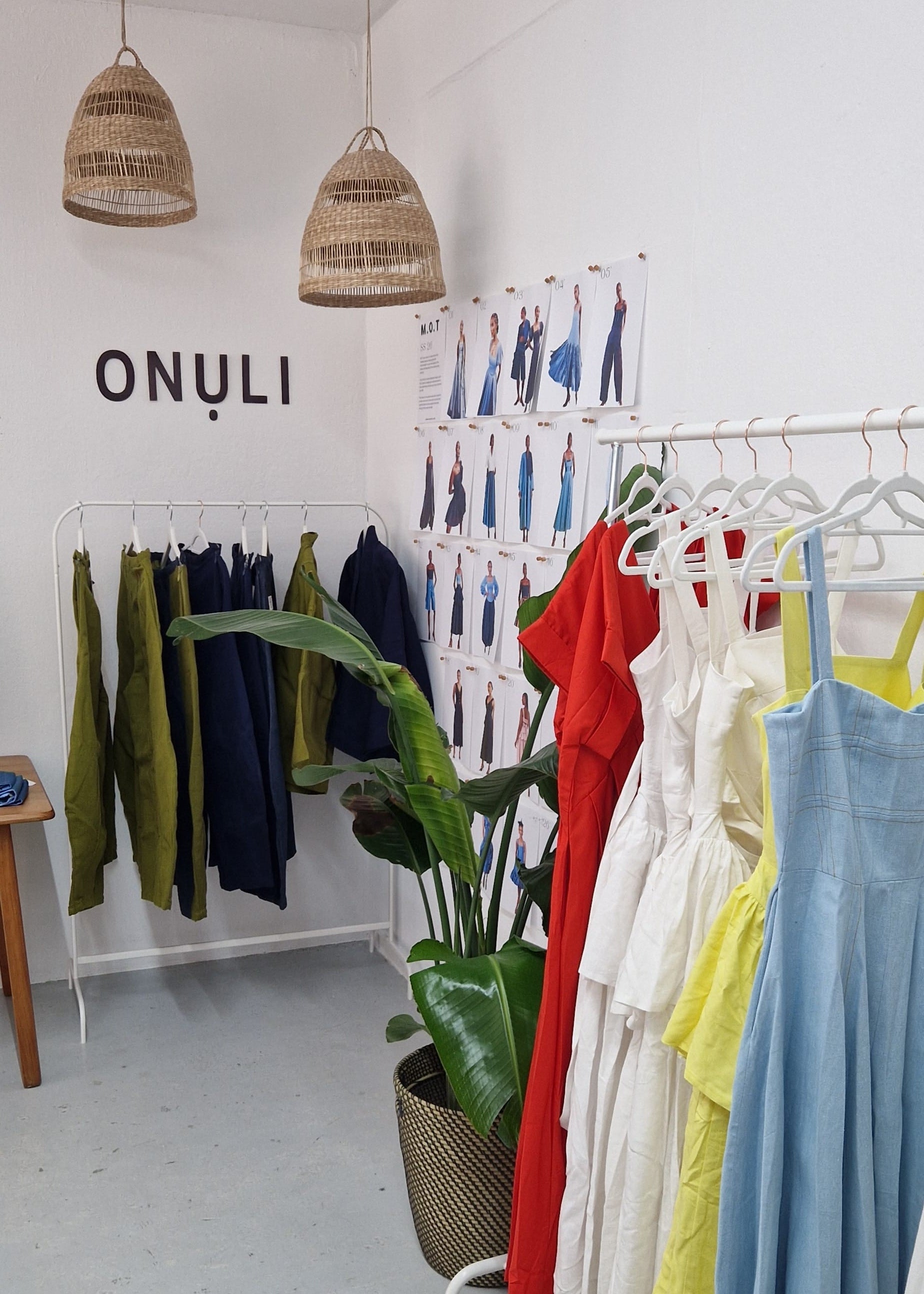 Clothing store interior with racks of colorful dresses and 'ONULI' branding.